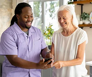 A man and woman looking at a cell phone.