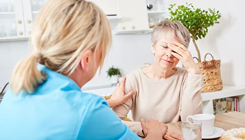 A woman is talking to another person in front of her.