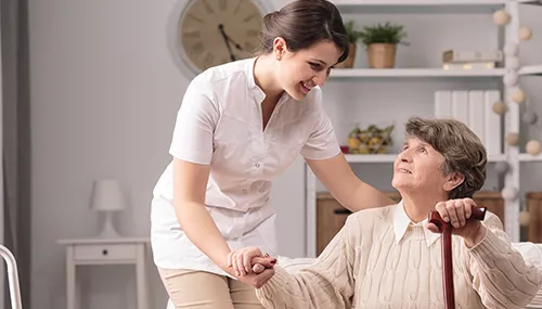 A woman is helping an old man