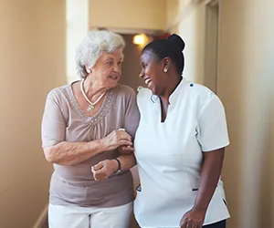 A woman and an older person standing next to each other.