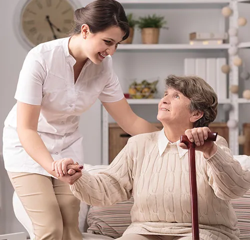 A woman holding the hand of an older person