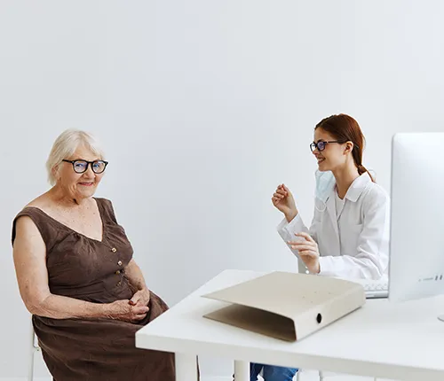 A woman sitting at a table with another person.