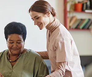 A woman standing next to another person in a room.