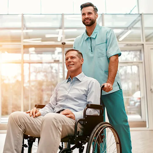 A man in a wheelchair and another man standing next to him.