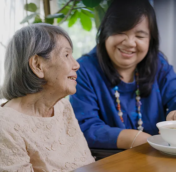 A woman and an older person sitting at a table