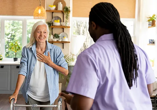 A man and woman are talking in the kitchen.