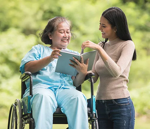 A woman showing an older lady something on her tablet.