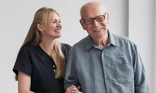 A woman standing next to an older man.