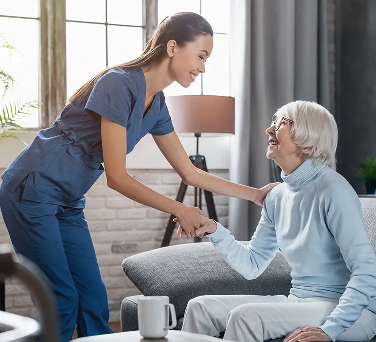 A woman shaking hands with an older man.