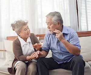 A man and woman sitting on the couch together.