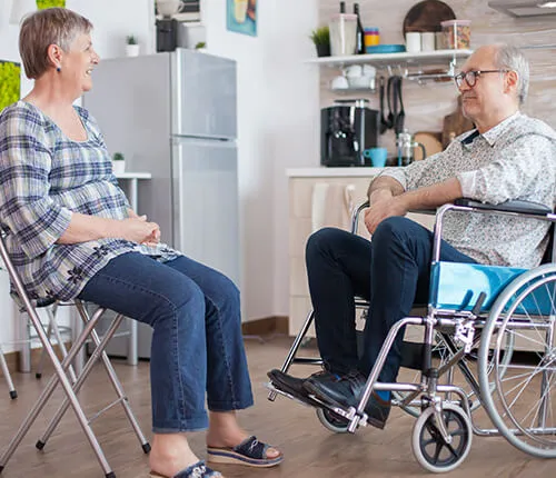 A group of people sitting in chairs and talking.