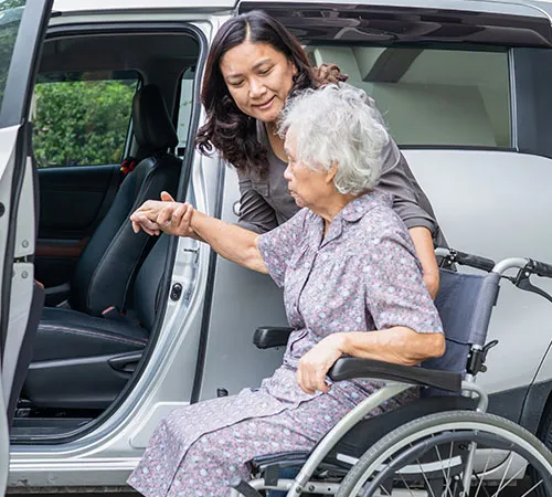 A woman in a wheelchair with an older person.