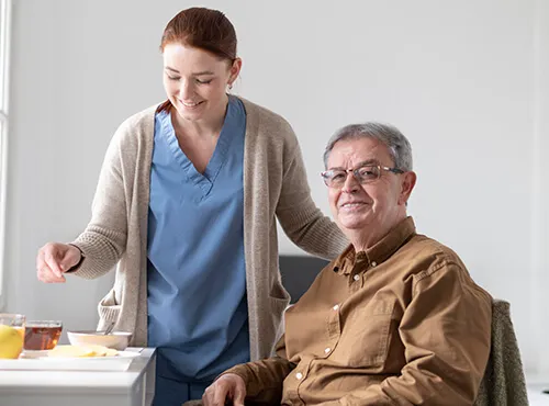 A woman standing next to an older man.