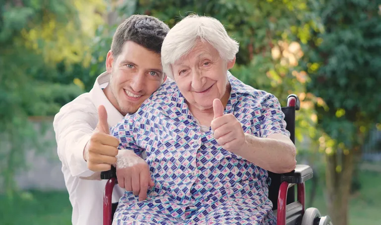 A man and an old woman giving thumbs up.