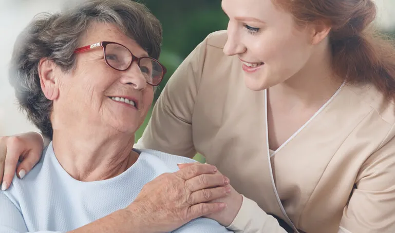 A woman and an older person smiling for the camera.