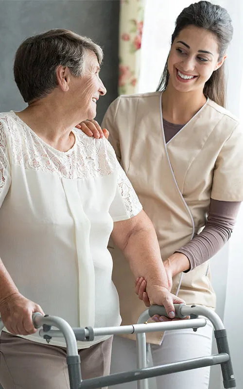 A woman and an older person smiling for the camera.