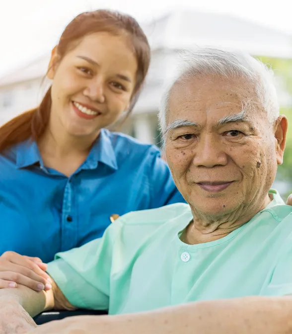 A woman standing next to an older man.