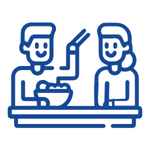 A blue line drawing of two people sitting at a table